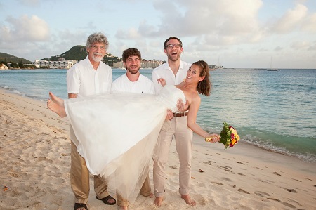 three men holding bride
