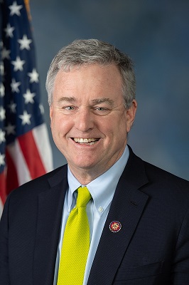 white man in suit and yellow tie, David Trone '77,