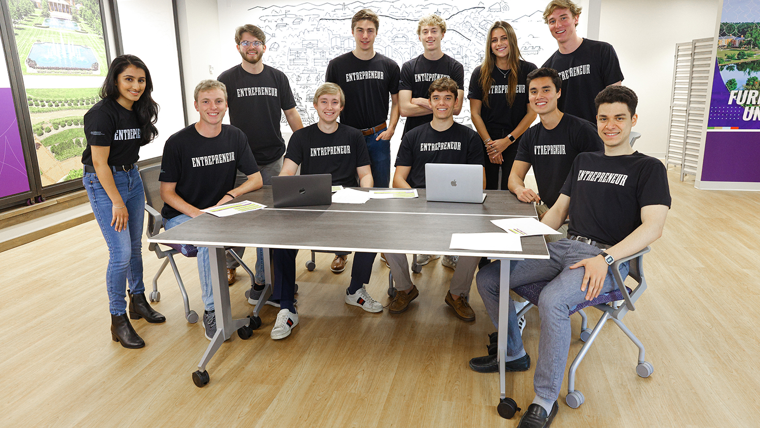 A group photo of students, all wearing black t-shirts that read "entrepreneur". 